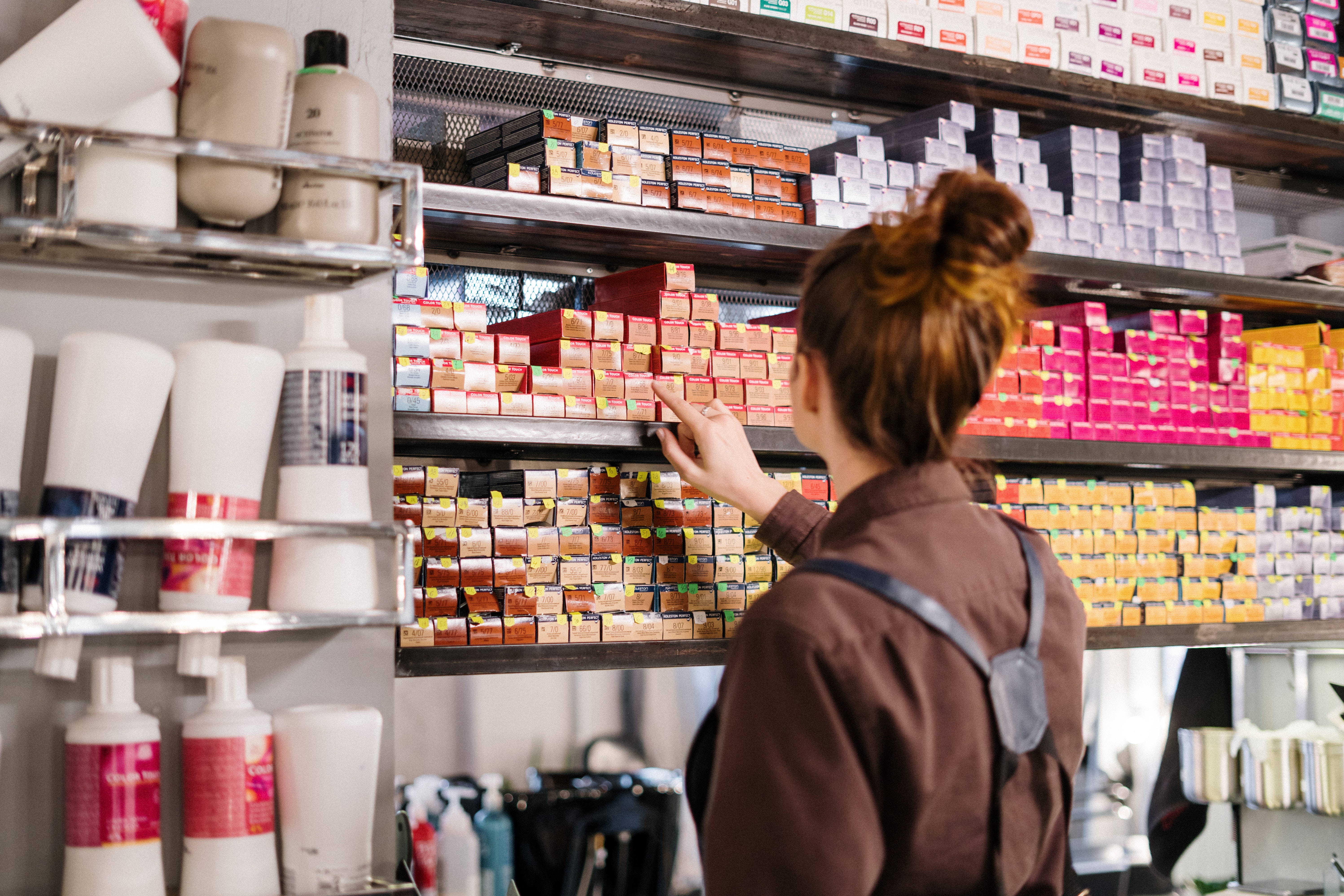 Woman standing in front of boxes of hair colour